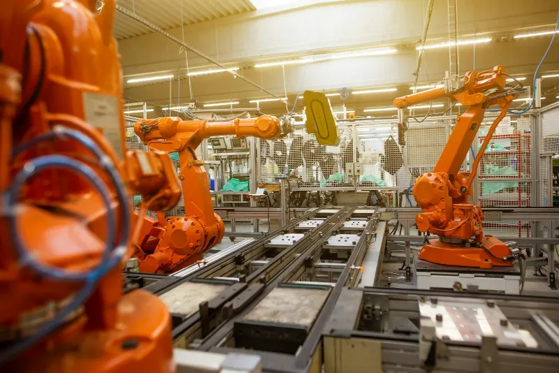Industrial robots welding on an automotive assembly line